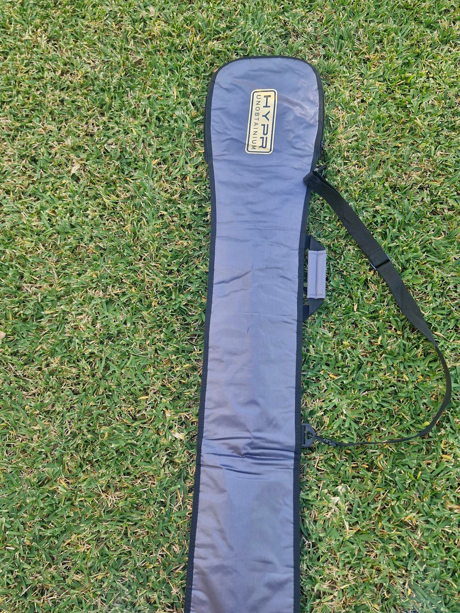 HYPR Paddle Bag – Premium Padded SUP & Surfboard Carry Case resting on grass.